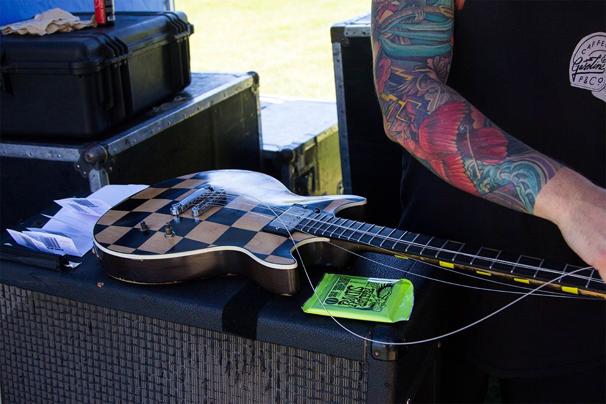 Reel Big Fish's tech, Brian, stringing up fresh Slinky's